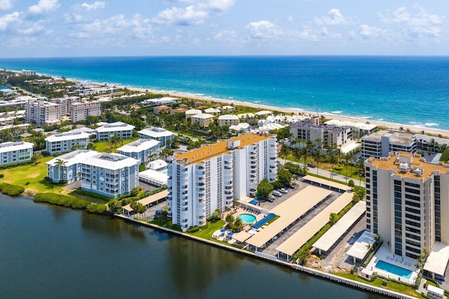 drone / aerial view with a beach view and a water view