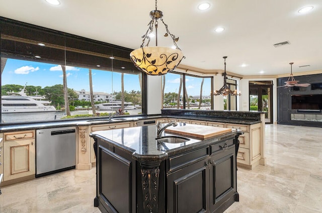 kitchen with sink, stainless steel dishwasher, crown molding, and an island with sink