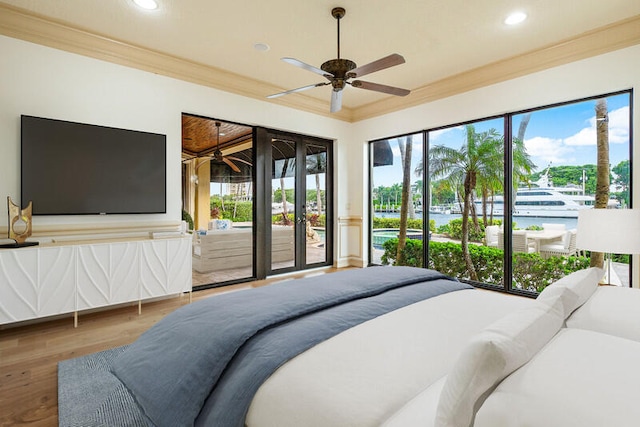 bedroom featuring multiple windows, crown molding, ceiling fan, and hardwood / wood-style flooring