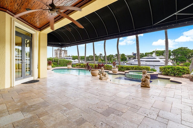 view of pool featuring an in ground hot tub, french doors, and ceiling fan