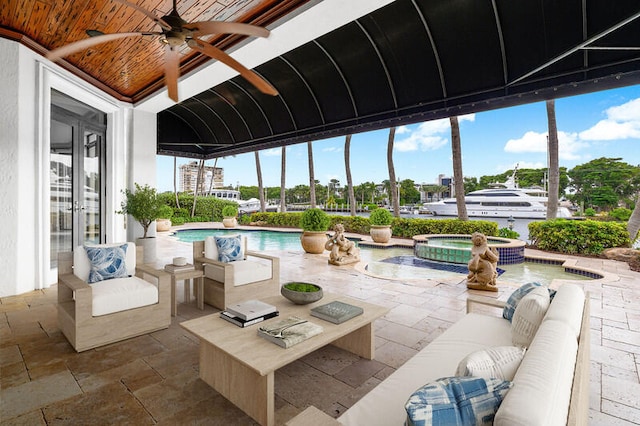 exterior space with outdoor lounge area, ceiling fan, and a pool with hot tub