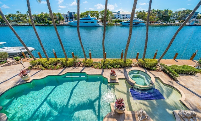 view of pool with a water view and an in ground hot tub