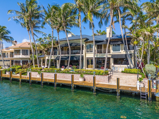 rear view of house featuring a water view