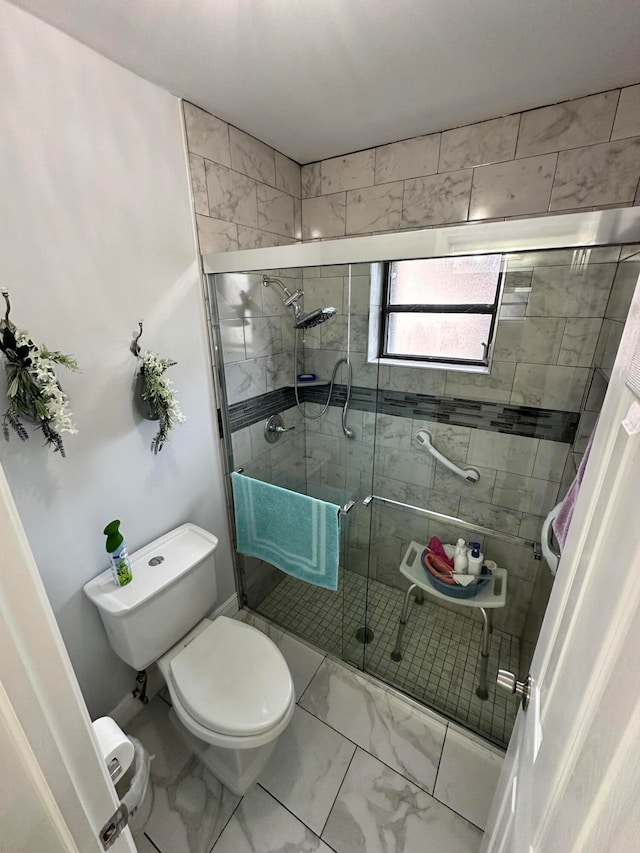 bathroom featuring walk in shower and toilet