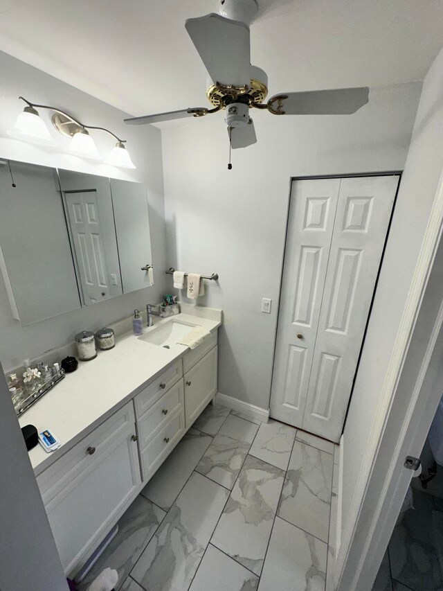 bathroom with ceiling fan and vanity