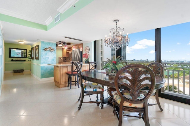 tiled dining area featuring a notable chandelier, ornamental molding, and a textured ceiling