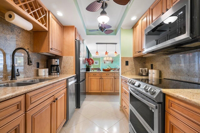 kitchen with ceiling fan, stainless steel appliances, tasteful backsplash, and sink