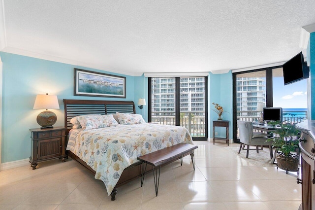 bedroom featuring crown molding, a wall of windows, a textured ceiling, access to outside, and light tile floors