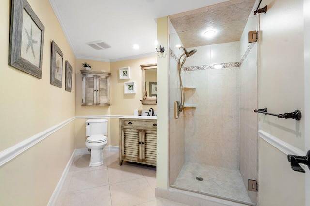 bathroom featuring tile flooring, crown molding, a tile shower, toilet, and vanity