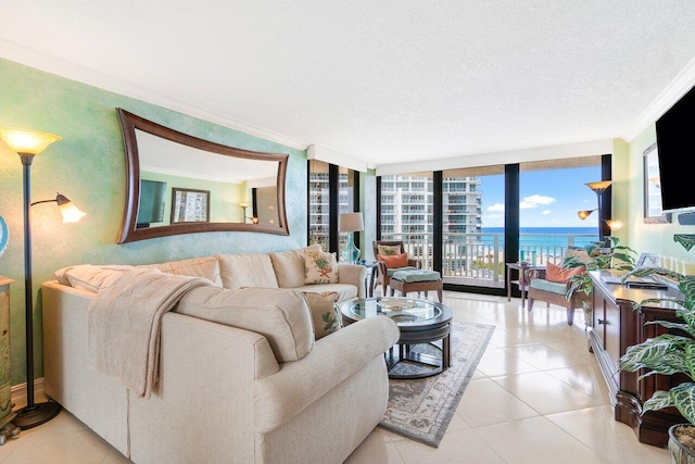 living room featuring a water view, tile flooring, a wall of windows, and crown molding