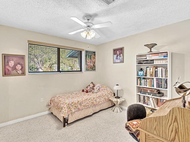 carpeted bedroom with a textured ceiling and ceiling fan