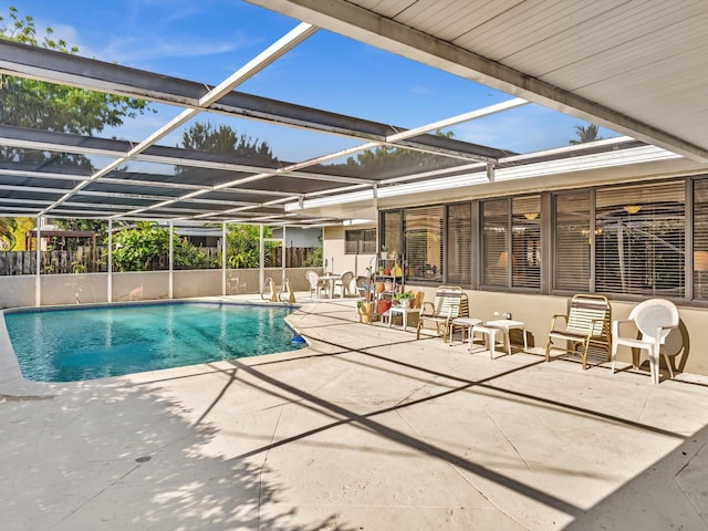 view of pool with a patio and glass enclosure