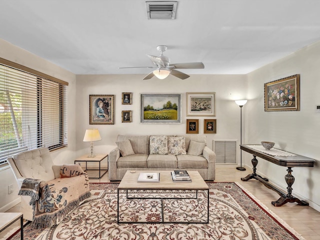 living room featuring ceiling fan and light hardwood / wood-style floors