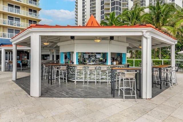 view of patio featuring a balcony and a bar