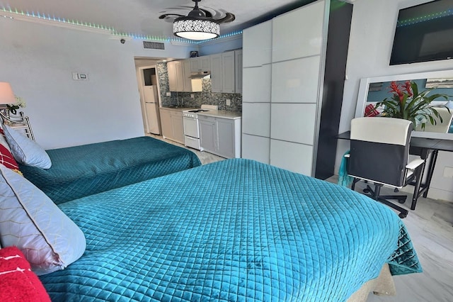 bedroom with light wood-type flooring and white fridge