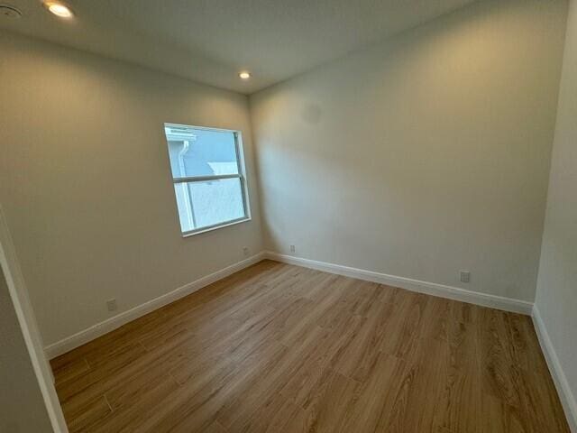 unfurnished room with light hardwood / wood-style floors