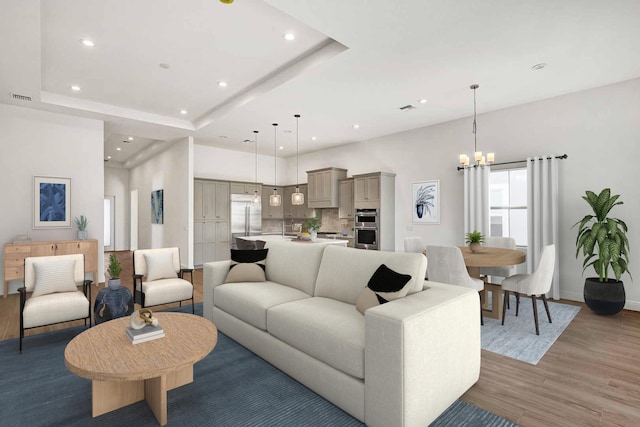 living area with recessed lighting, a chandelier, a raised ceiling, light wood finished floors, and visible vents