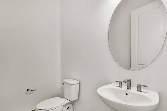 half bath with toilet and a sink
