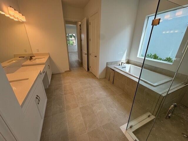 bathroom with vanity, separate shower and tub, and tile patterned floors