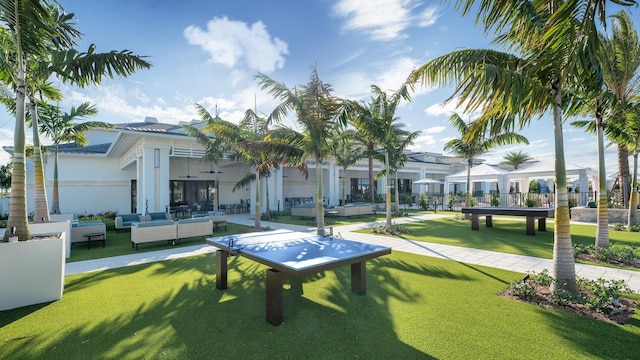 view of property's community with an outdoor living space, a patio, and a yard