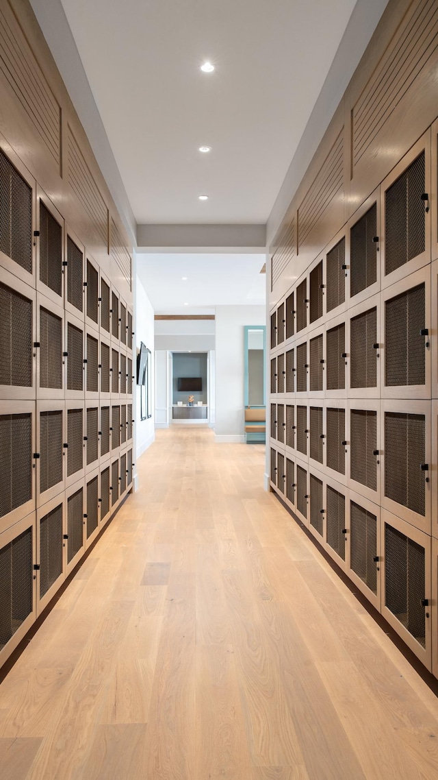 hall featuring wood finished floors and recessed lighting