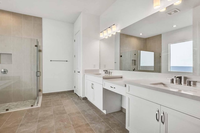 bathroom featuring vanity and a shower with shower door