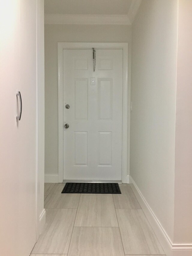 doorway to outside with ornamental molding