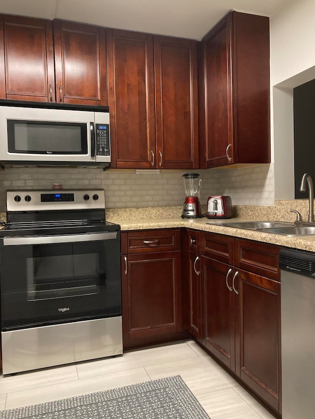 kitchen featuring backsplash, sink, and stainless steel appliances