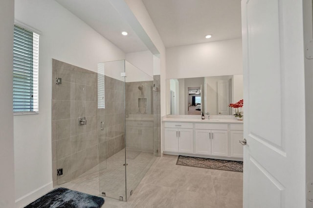 bathroom featuring tile flooring, an enclosed shower, and vanity