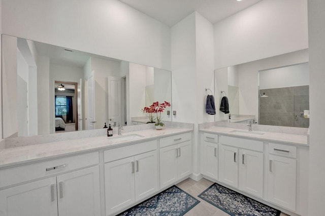 bathroom featuring tiled shower, tile floors, and large vanity