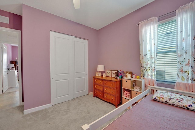 bedroom featuring light carpet, a closet, and ceiling fan