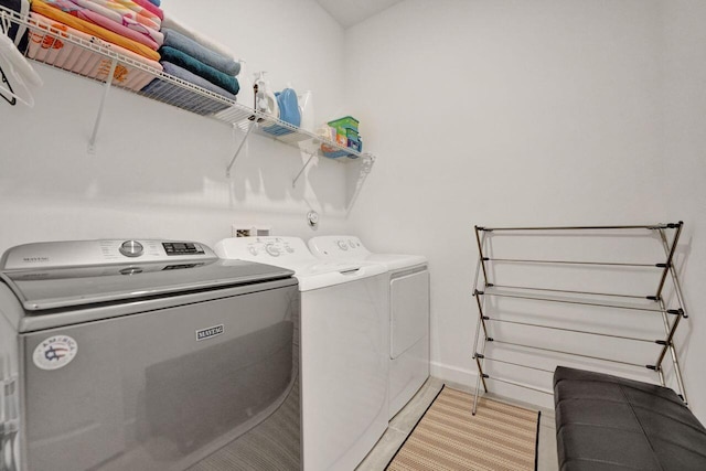 clothes washing area featuring washing machine and clothes dryer