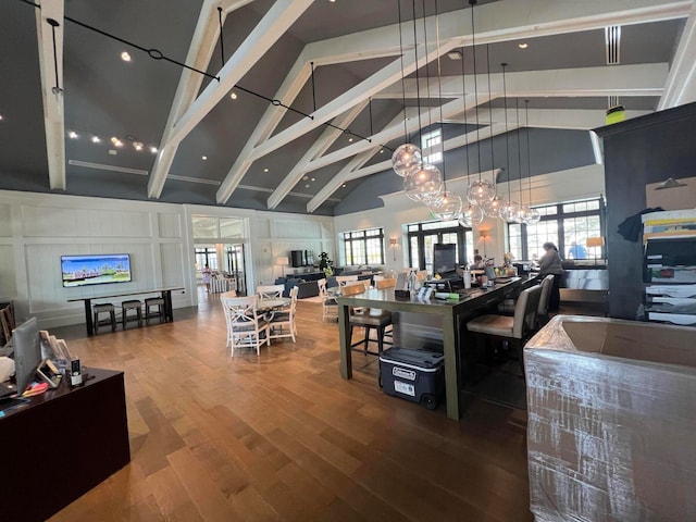 dining room with a chandelier, hardwood / wood-style floors, high vaulted ceiling, beamed ceiling, and french doors