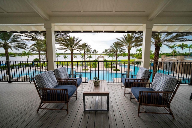 deck featuring an outdoor hangout area and a fenced in pool