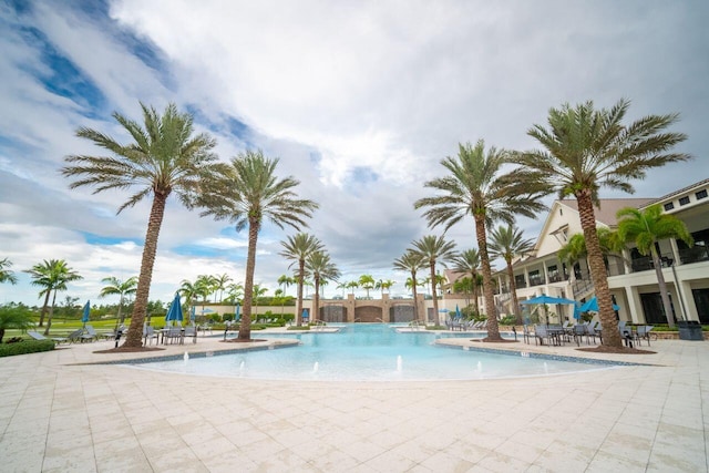 view of swimming pool with a patio area and pool water feature