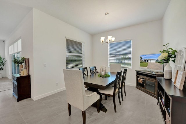 dining space with a notable chandelier and light tile flooring