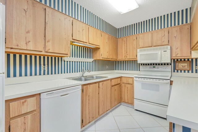 kitchen featuring light brown cabinets, sink, white appliances, and light tile floors