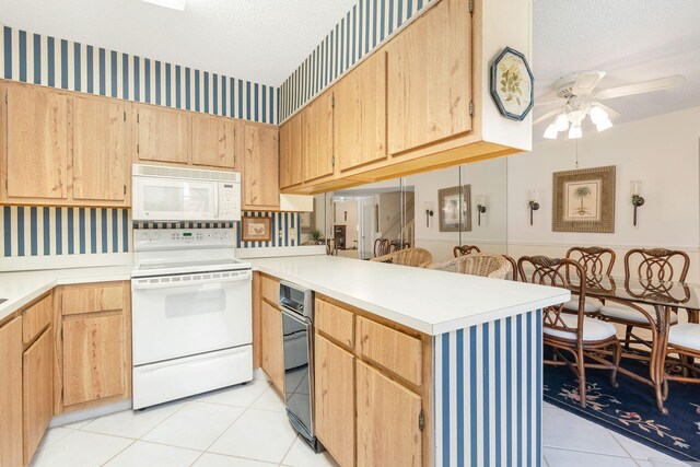 kitchen with white appliances, a textured ceiling, ceiling fan, and light tile floors