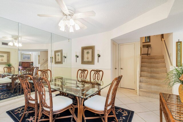 dining area featuring a textured ceiling, light tile flooring, and ceiling fan