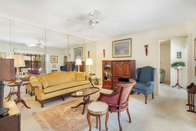 living room with ceiling fan and light colored carpet