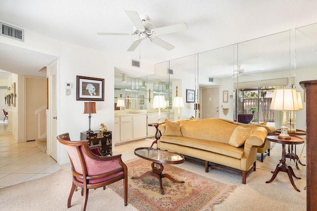 living room with ceiling fan and light tile floors