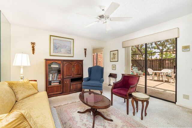 living room featuring ceiling fan and carpet floors