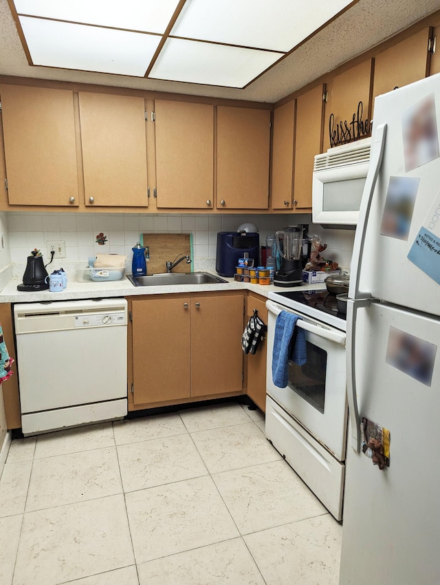 kitchen featuring white appliances, sink, light tile patterned flooring, and backsplash