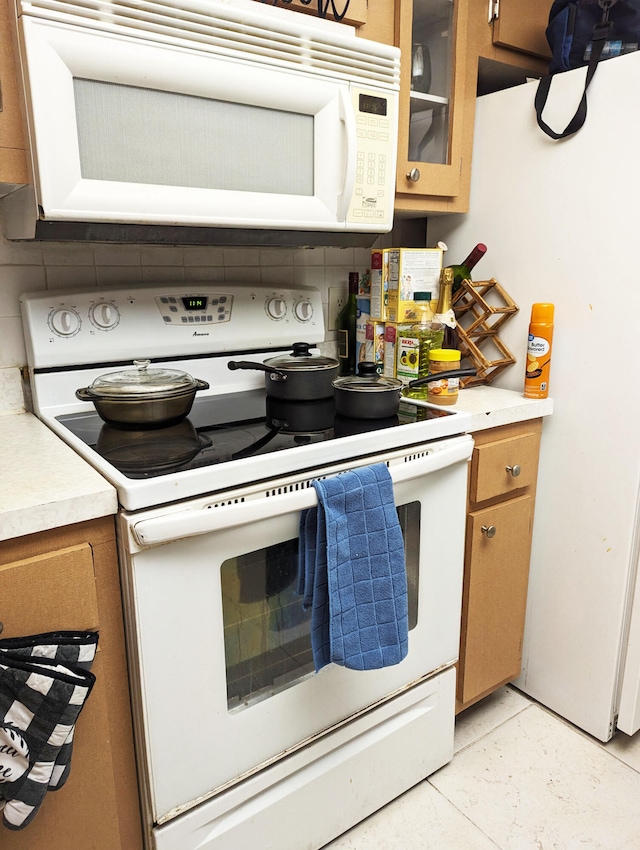 kitchen featuring white appliances and light tile patterned floors