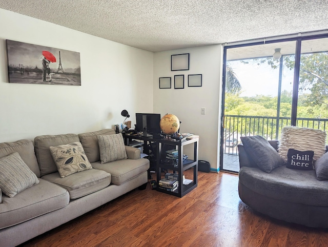 living room with hardwood / wood-style floors, floor to ceiling windows, a textured ceiling, and a wealth of natural light