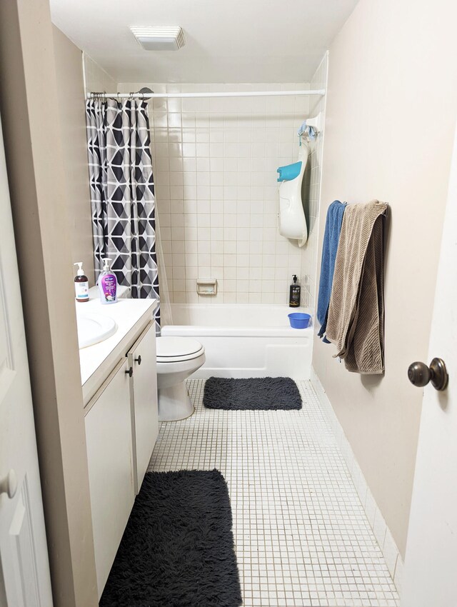 full bathroom featuring shower / bath combo with shower curtain, vanity, tile patterned flooring, and toilet