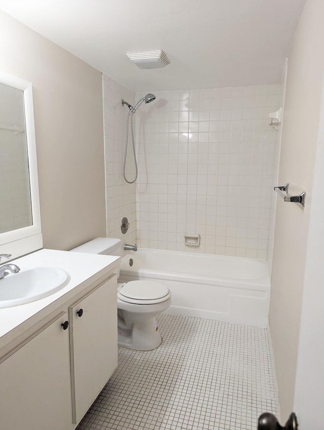 full bathroom with tiled shower / bath, vanity, toilet, and tile patterned flooring