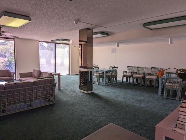 game room featuring ceiling fan, a textured ceiling, carpet flooring, and floor to ceiling windows