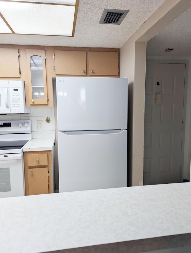 kitchen with white appliances, decorative backsplash, and a textured ceiling