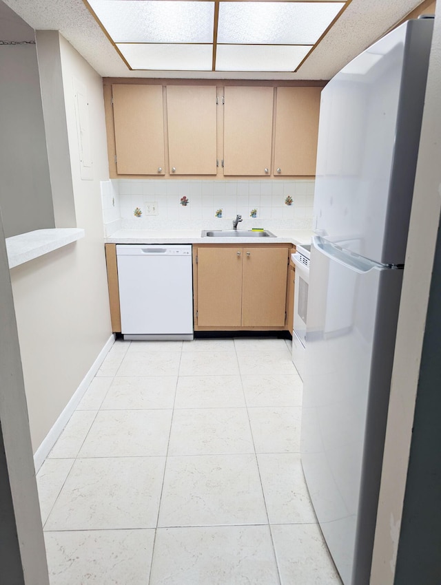 kitchen featuring sink, light tile patterned floors, light brown cabinets, white appliances, and backsplash